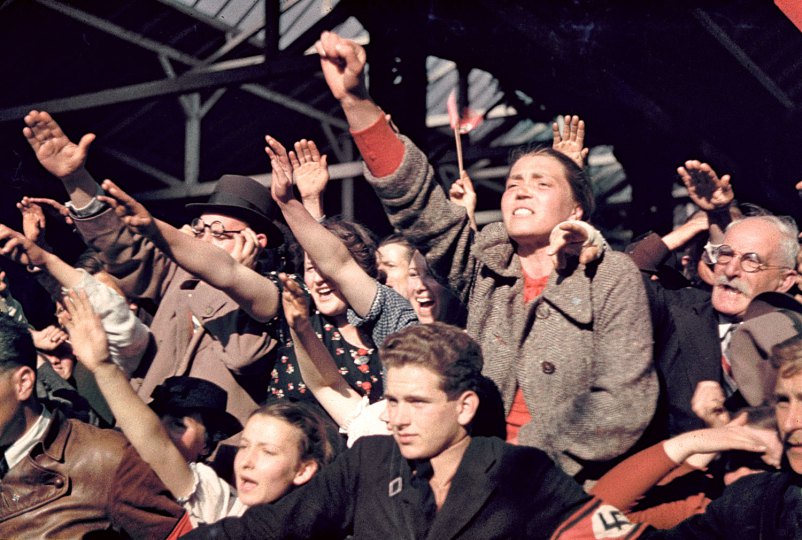 Crowds cheering Adolf Hitler's campaign to unite Austria and Germany, 1938.
